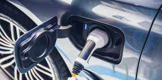 Electric car charging port with plugged-in connector