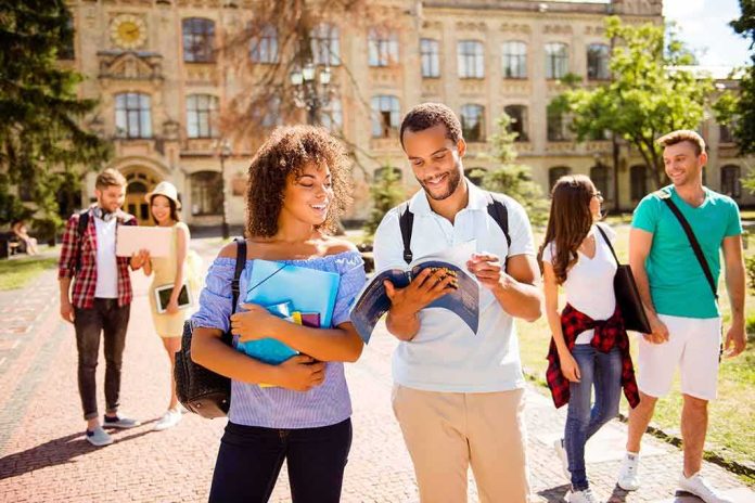 College students walking on campus with books and backpacks