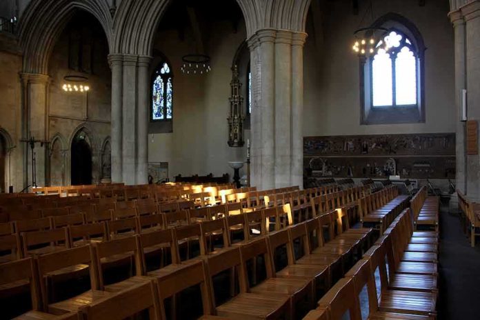 Rows of wooden chairs inside a Gothic church nave